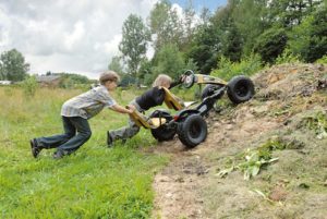 Boys pushing go kart