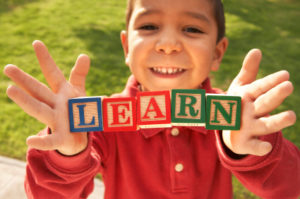 Boy holding Blocks Learn
